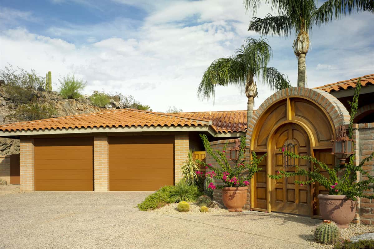 Tan house with a brown, ribbed panel garage door