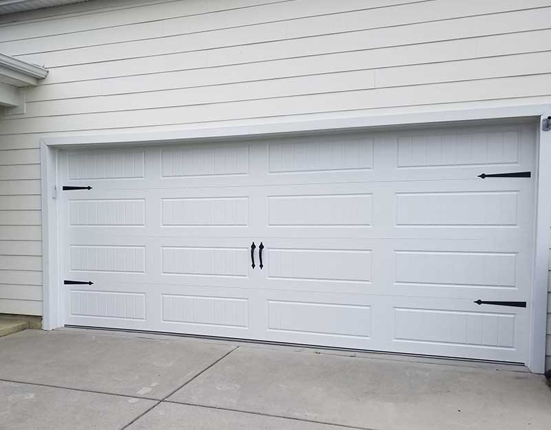 "After" image of white carriage house garage door