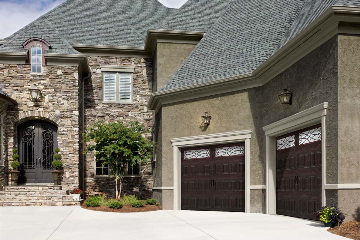 Tan house with a garage door that has raised panels